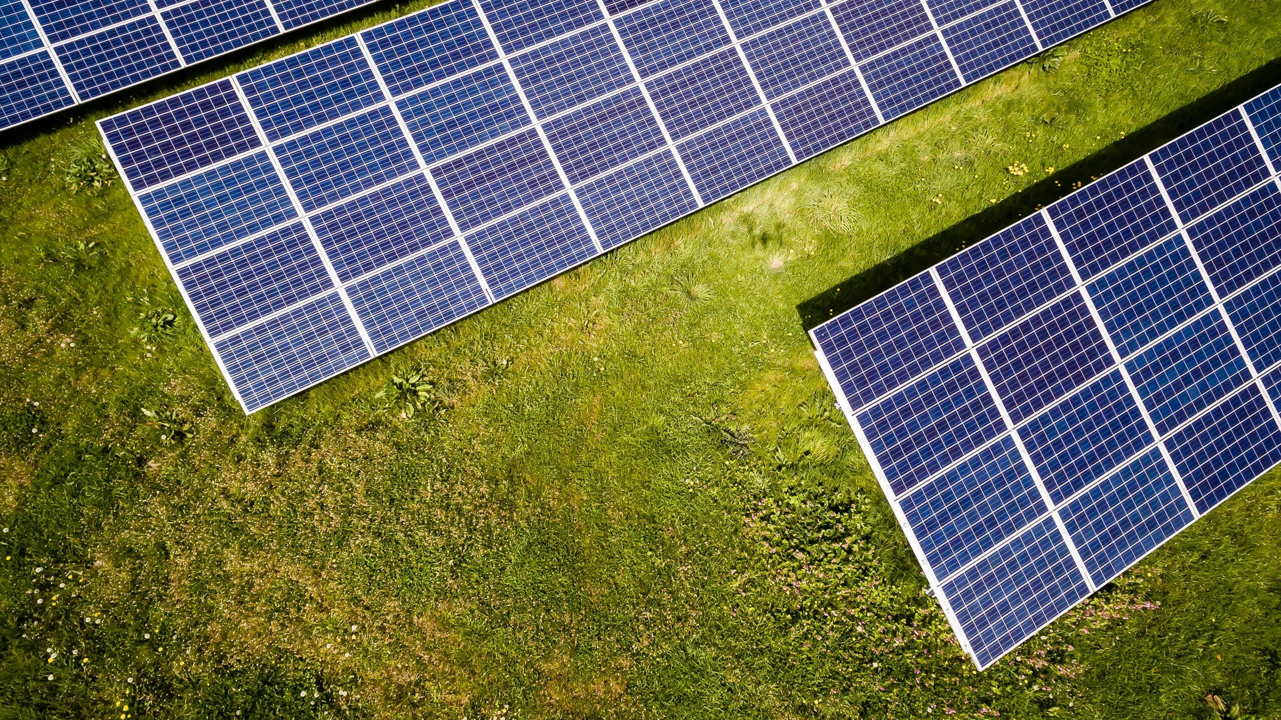 Arial view of three solar panels in field
