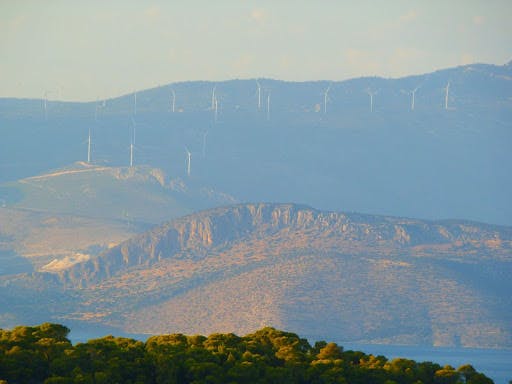 A wind farm up in a mountainous region