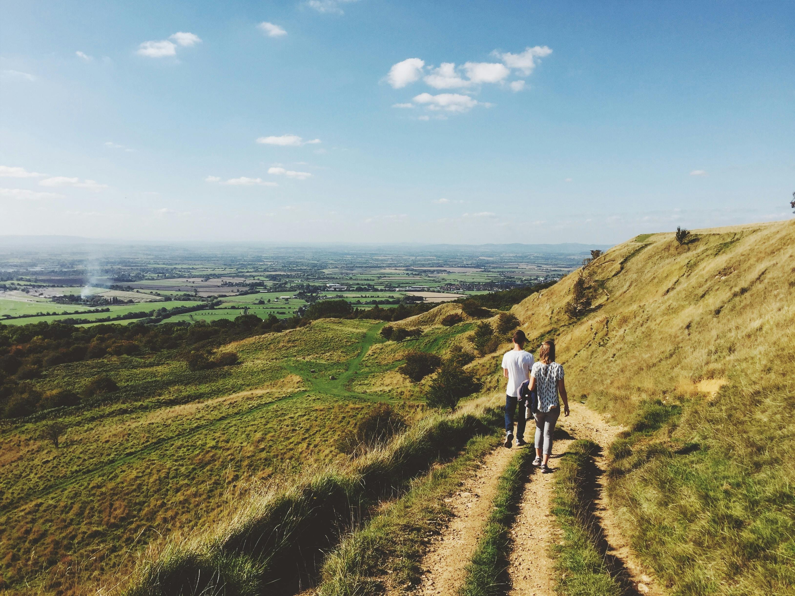 Two people walking on a path in the English countryside